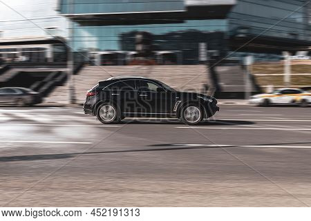 Car Infiniti Qx70 Suv Is Driving On Urban Speedway With City Buildings Background. Moscow, Russia - 