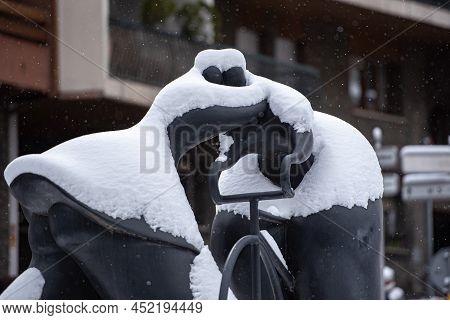 Escaldes Engordany, Andorra: 2022 April 2: Sculpture By Botero Cyclist And Woman Kiss. Whit Snowfall
