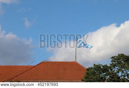 Large Flag Of The Region Of Bavaria Where Munich In Germany Is Flying On The Roof Of The Brewery