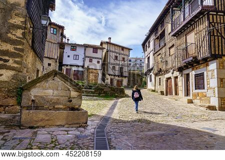 Woman Walking Through The Medieval Streets Of The Mountain Village Of La Alberca, Salamanca.