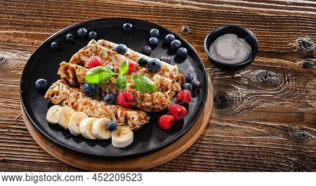 A Plate Of Pancakes With Cheese And Fruits