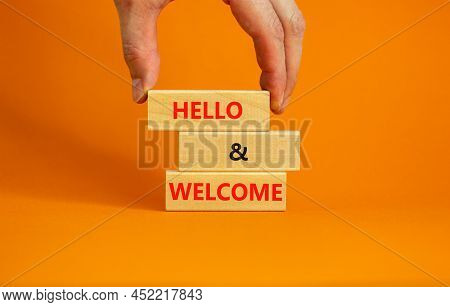 Hello And Welcome Symbol. Concept Words Hello And Welcome On Wooden Blocks. Businessman Hand. Beauti
