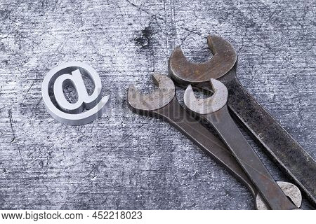 The Photo Shows Various Rusty Wrenches On A Gray Background With A Add Sysmbol