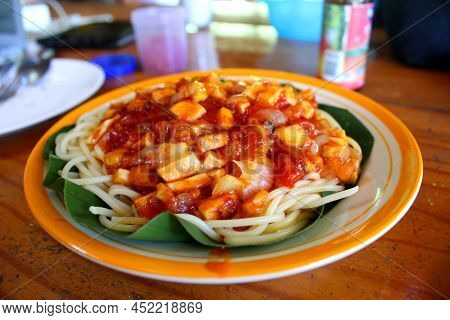 Boiled Noodles And Vegetables Served In Green Leaf And White Ceramic Plate. Freshly Cooked Hot Meal 