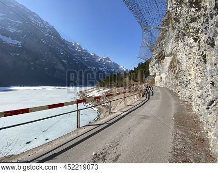 Paved Road By The Alpine Resevoir Lake Klöntalersee (kloentalersee Or Klontaler Lake) And In The Klö