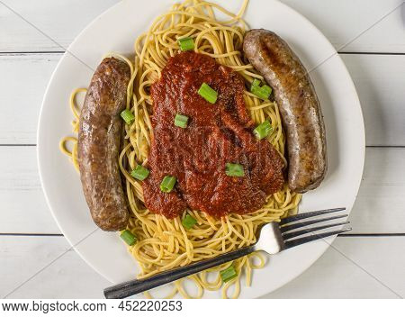 Spaghetti Top  With Sauce And Green Onions Plus Sweet Italian Sausage