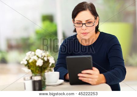 beautiful modern mature woman using tablet computer