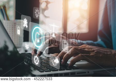 Copyright Or Patent Concept, Person Hand Using Laptop Computer On Desk With Vr Screen Copyright Icon