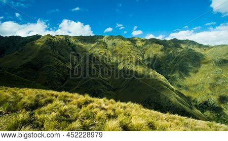 Huge Green Mountains With Blue Sky And Clouds