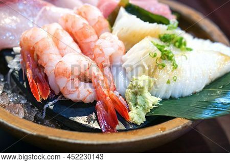 The Sashimi Set Is Beautifully Arranged In A Wooden Plate. Japanese Cuisine Buffet. Chef's Choice: S