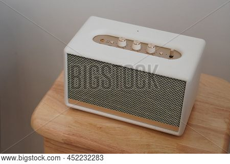Top View White And Gold Loudspeaker On Wooden Chair, On White Wall Background, Technology, Object, F