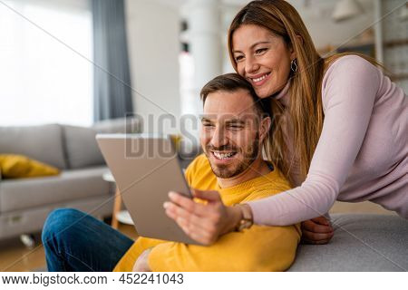 Young Couple At Home Websurfing On Tablet, Internet