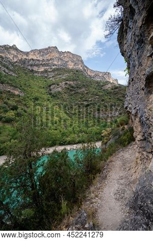 Deep Turquoise River At The Bottom Of A Vertical Canyon
