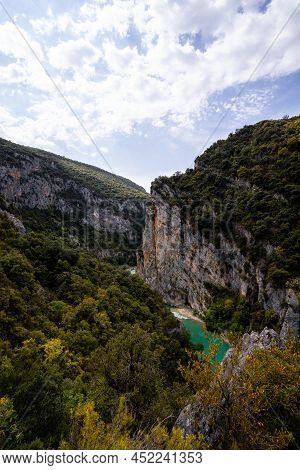 Deep Turquoise River At The Bottom Of A Vertical Canyon