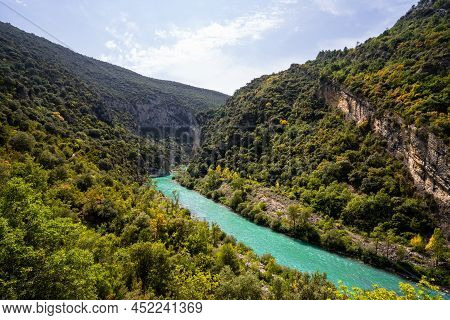 Deep Turquoise River At The Bottom Of A Vertical Canyon