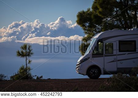 Modern Elegant Motorhome Cozy Home Parked Off Road With Blue Sky And Clouds In Background. Concept O