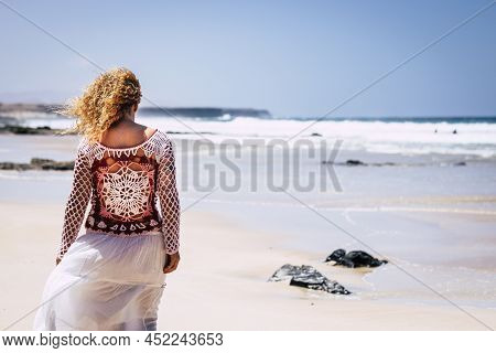 Back View Of Tourist Woman Walking At The Beach On White Sand And Blue Clean Caribbean Ocean Water I