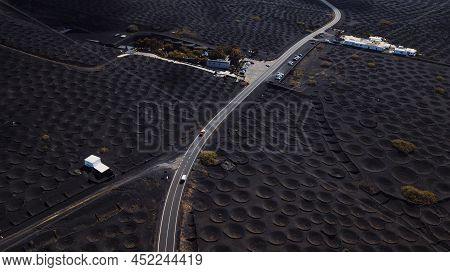Drone View Of Volcanic Landscape And Long Asphalt Road In The Middle. Concept Of Travel And Discover