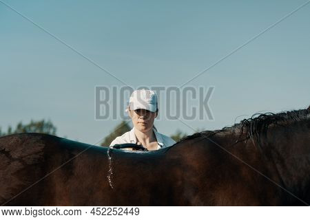 Woman, 40 Years Old, Washing Horse With Hose In Outdoors, Close Up.