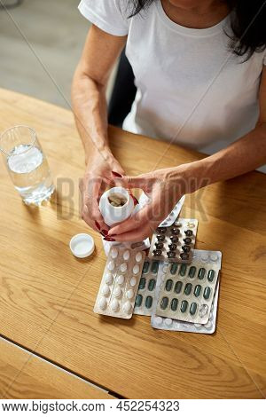 Mature Sick Woman Having Antibiotic, Aspirin Pills From Bottle From Flu