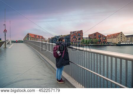 Brunette Girl In Warm Clothes Looks Leaning On Handrails Inner Harbour Pedestrian And Bicyclist Brid