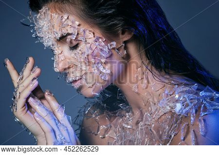 Female Face Covered With A Small Pieces Of Glass