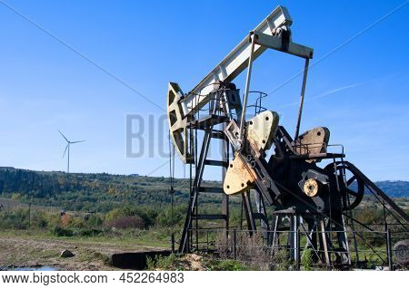 An Oil Pump Is On A Background Mountains