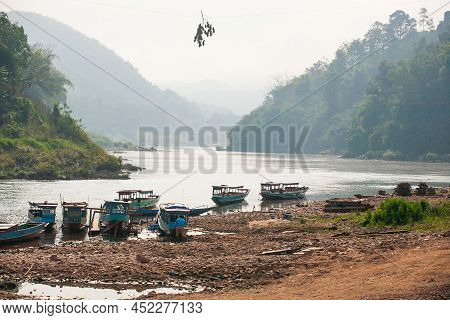 The Landscape Of The Nam U River And Passenger Boats At A Local Pier In The Evening. Phongsaly, Nort