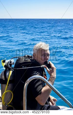 Scuba Diver Before Diving. Diving Lesson In Open Water. Male In Scuba Diving Suit Is Preparing To Di