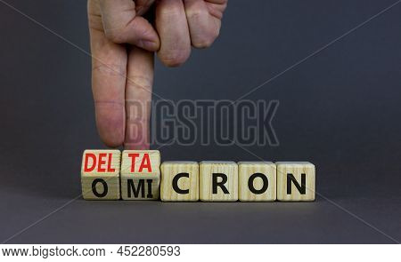 Covid-19 Omicron Or Deltacron Symbol. Doctor Turns Cubes And Changes The Word Omicron To Deltacron. 