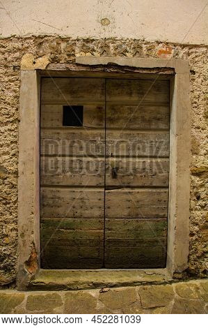 An Old Wooden Door In Poffabro, An Historic Medieval Village In The Val Colvera Valley In Pordenone 