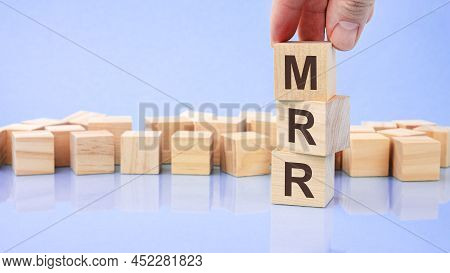 Close Up Image Hand Of A Young Businessman Holding A Wooden Cube With Letter M. Mrr On Wooden Cube O