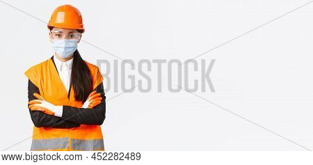 Covid-19 Safety Protocol At Enterpise, Construction And Preventing Virus Concept. Confident Asian Fe