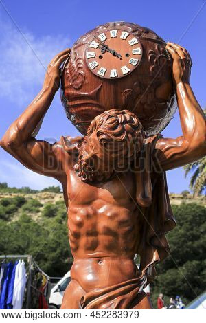 Guardamar, Alicante, Spain- April 3, 2022: Wooden Atlas Clock For Sale At An Antiques Flea Market Ca