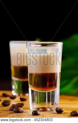 Shots Of Flaming B-52 Cocktail Placed On A Bar Counter. B-52 Shot Composed Of Three Liqueurs