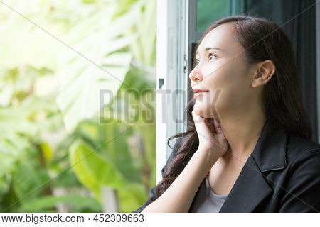 Beautiful Asian Business Woman Wearing Black Suit Relaxing At The Window And Admiring Nature And Cop