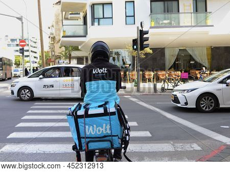 17.03.2022 Tel Aviv. Israel - Food Delivery Wolt. Delivery Courier - Back At Crosswalk. Close-up Bra