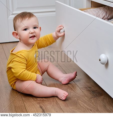 Danger For The Baby To Pinch The Hand Of The Cabinet Door Or Chest Of Drawers. Protect Children From