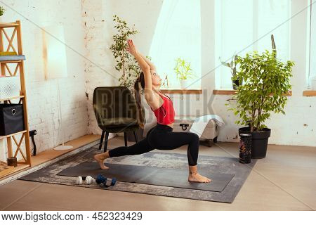 Youga. Young Beautiful Sportive Girl Doing Exercises With Sport Equipment At Home, Indoors. Concept 