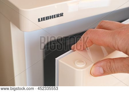 Tambov, Russian Federation - April 15, 2021 A Woman Hand Opening A Liebherr Fridge Door.