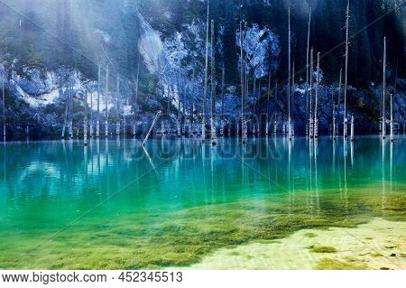Landscape Of A Mountain Lake With Trunks Of Flooded Fir Trees. Kaindy Lake In Kazakhstan. Kolsay Lak