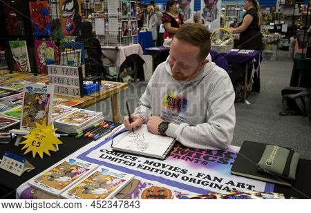 Doncaster, Yorkshire, England- April 3, 2022. Male Artist Drawing At Doncaster Comic Con 2022.