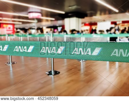 London, Uk, July 2019: Green Belt Barrier With White Ana All Nippon Airways Logo. Ana All Nippon Air