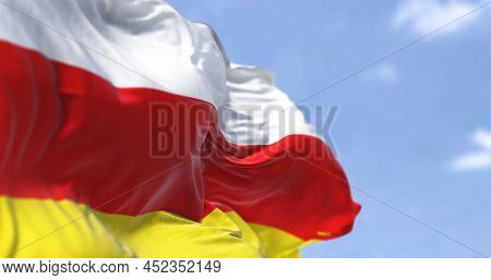 Detail Of The National Flag Of South Ossetia Waving In The Wind On A Clear Day. South Ossetia Is A B