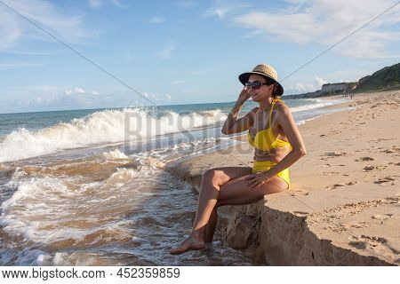 Fit Women In A Yellow Bikini At The Beach Known As Pitinga, In Arraial D\' Ajuda, Bahia, Brazil