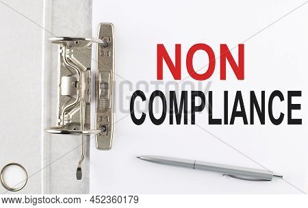 Non Compliance Text On Paper Folder With Pen. Business Concept