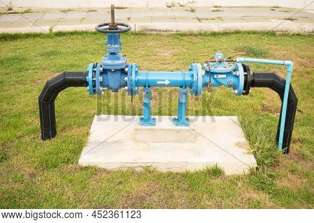Pumps, Valves And Blue Steel Pipes At Park. Self Priming Sewage Pump Open Bare Shaft For Repair In G