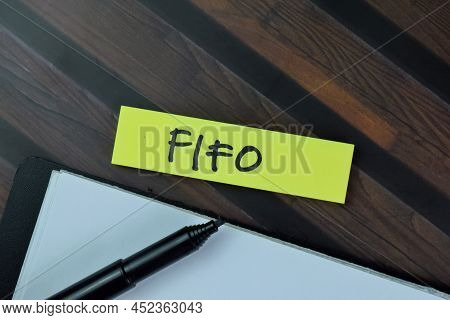 Fifo Write On Sticky Notes Isolated On Wooden Table.