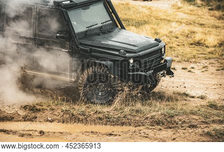 Low Angle View Of Front Of Suv On Mountain Road. Extreme Off Road Tour In A Forest. Off-road Car On 
