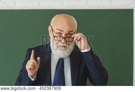 Academic Success. Mature Elegant Professor With Glasses. School Thinking Teacher Or College And Univ